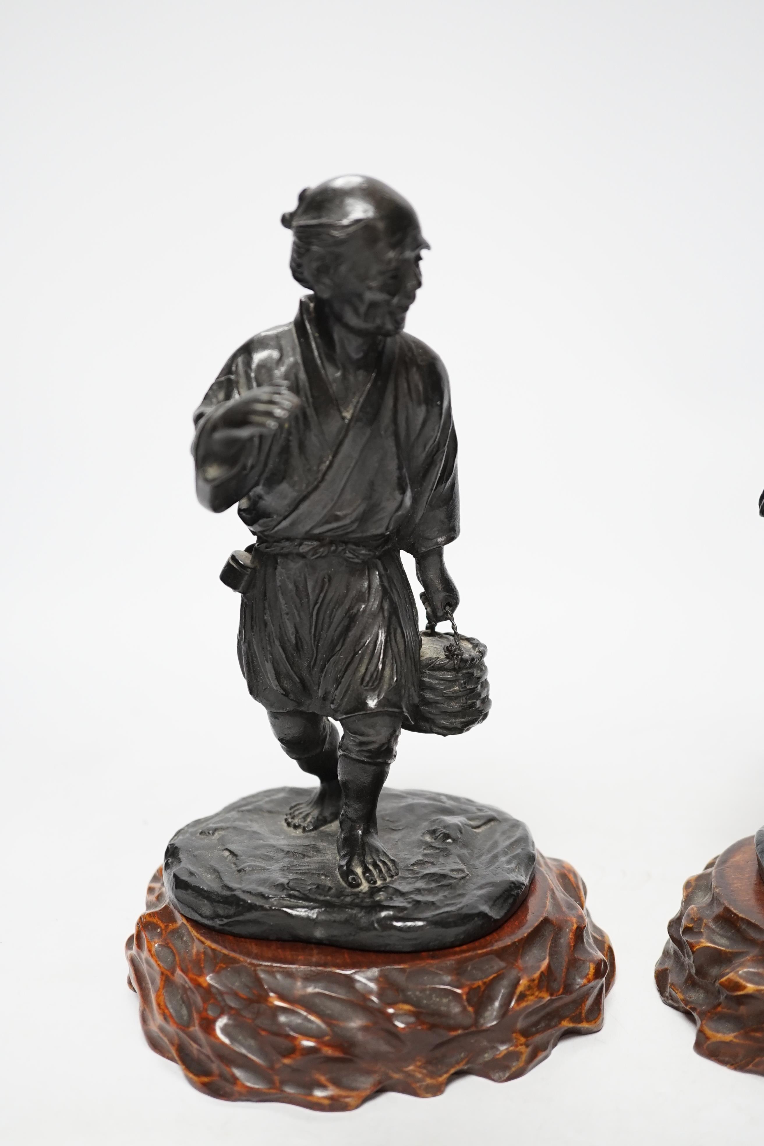 Two Japanese Meiji period bronzes, a water carrier and a woman playing a Shamisen, both signed, each with wooden plinths, largest 22cm high